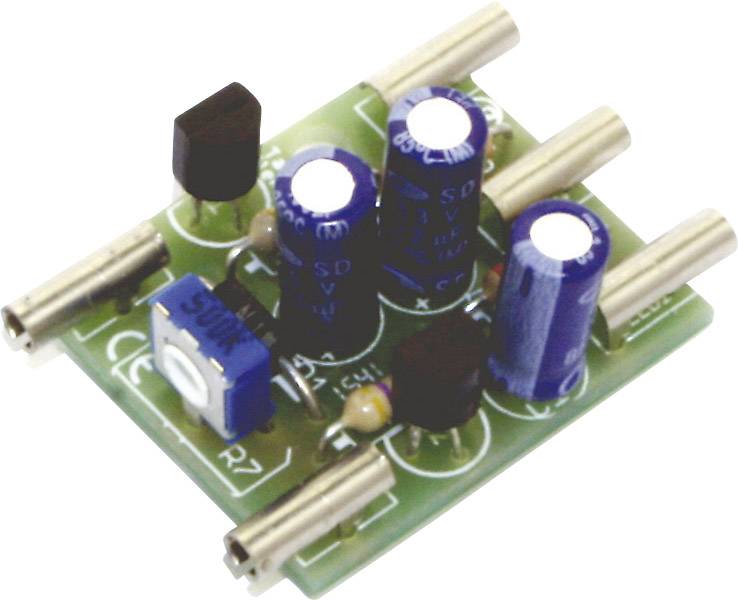 A green circuit board with blue and black capacitors, metal pins, and an adjustable blue resistor in the centre.