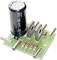 Electronic circuit board with capacitor, transistors and resistors. Components arranged on green printed circuit board for circuit assembly.