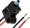 Small limit switch with blue cap and two exposed cables in red and black, used for controlling electrical devices.