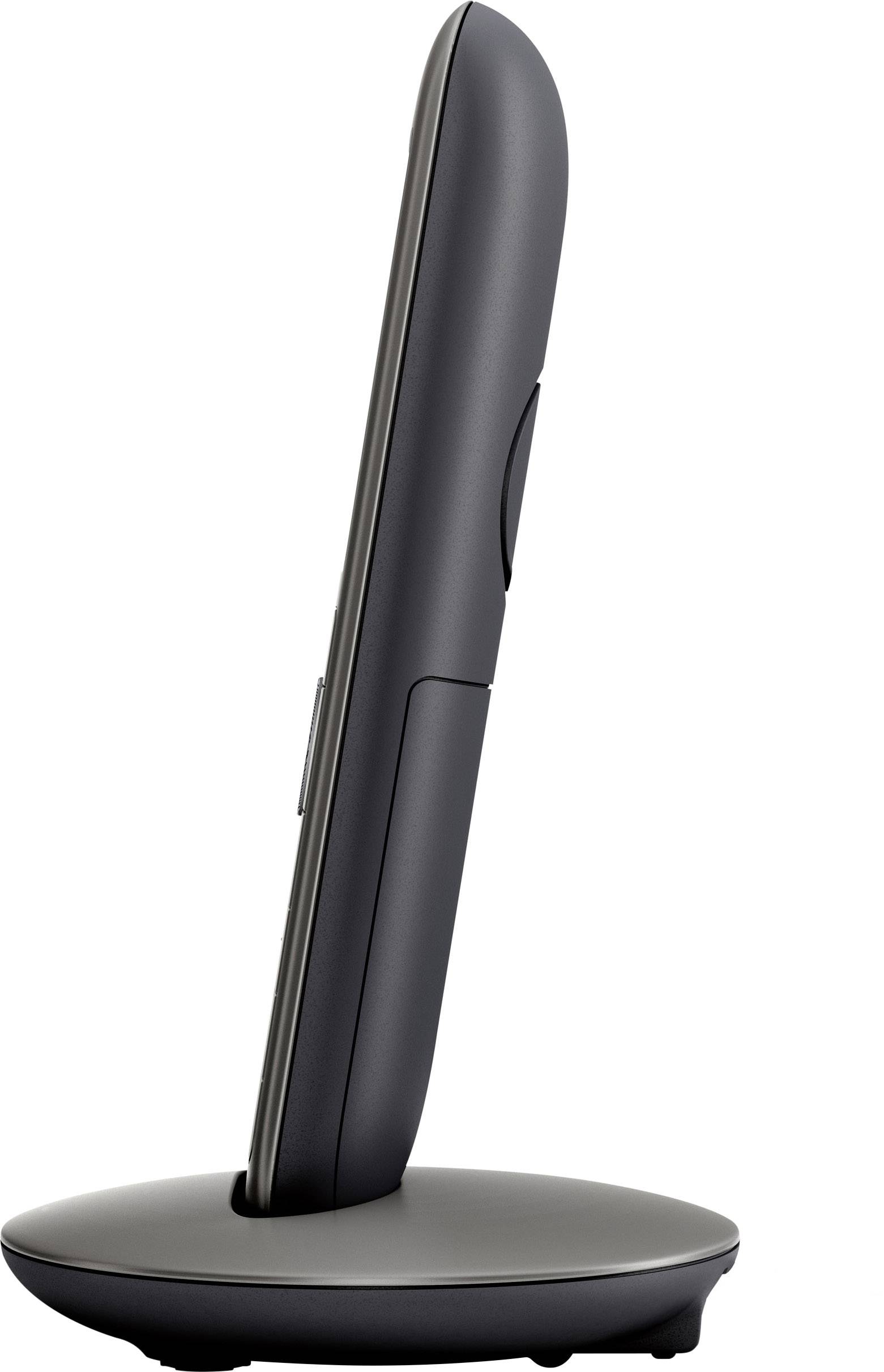 Cordless telephone viewed from the side, sitting on its charging station; sleek, modern design.