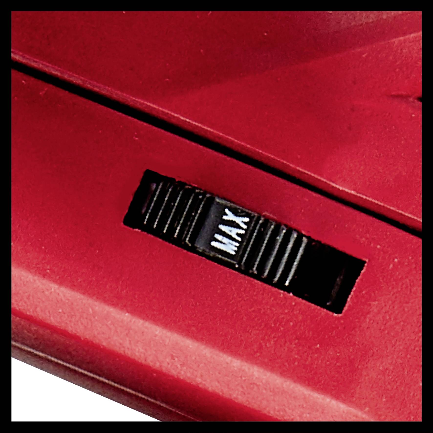 Close-up of a red switch on a device, set to 'MAX'. Could be part of a household appliance's power control mechanism.