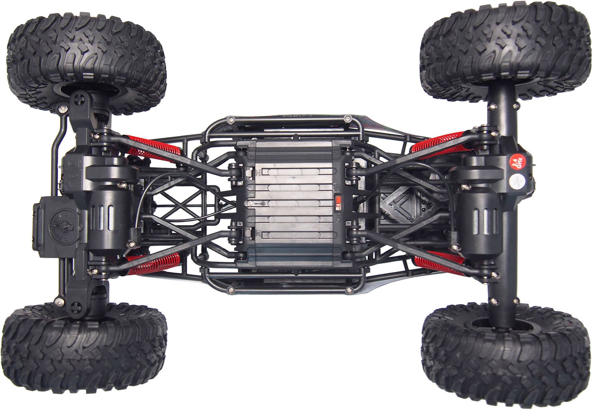Remote-controlled car from underneath, showing axles, springs, and chassis.