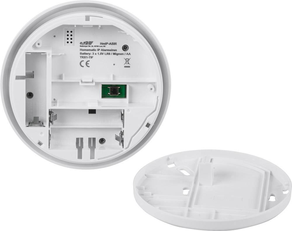 Rear view of a circular smoke detector by Alarm.com, showing the battery compartment and mounting plate.