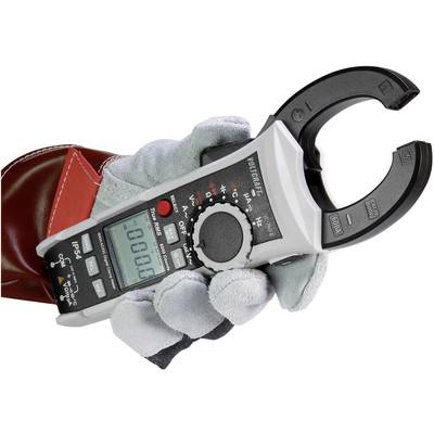 Electrician's hand holding a digital clamp multimeter. It is not displaying any measurement values. Glove and device are used for safety during measurements.