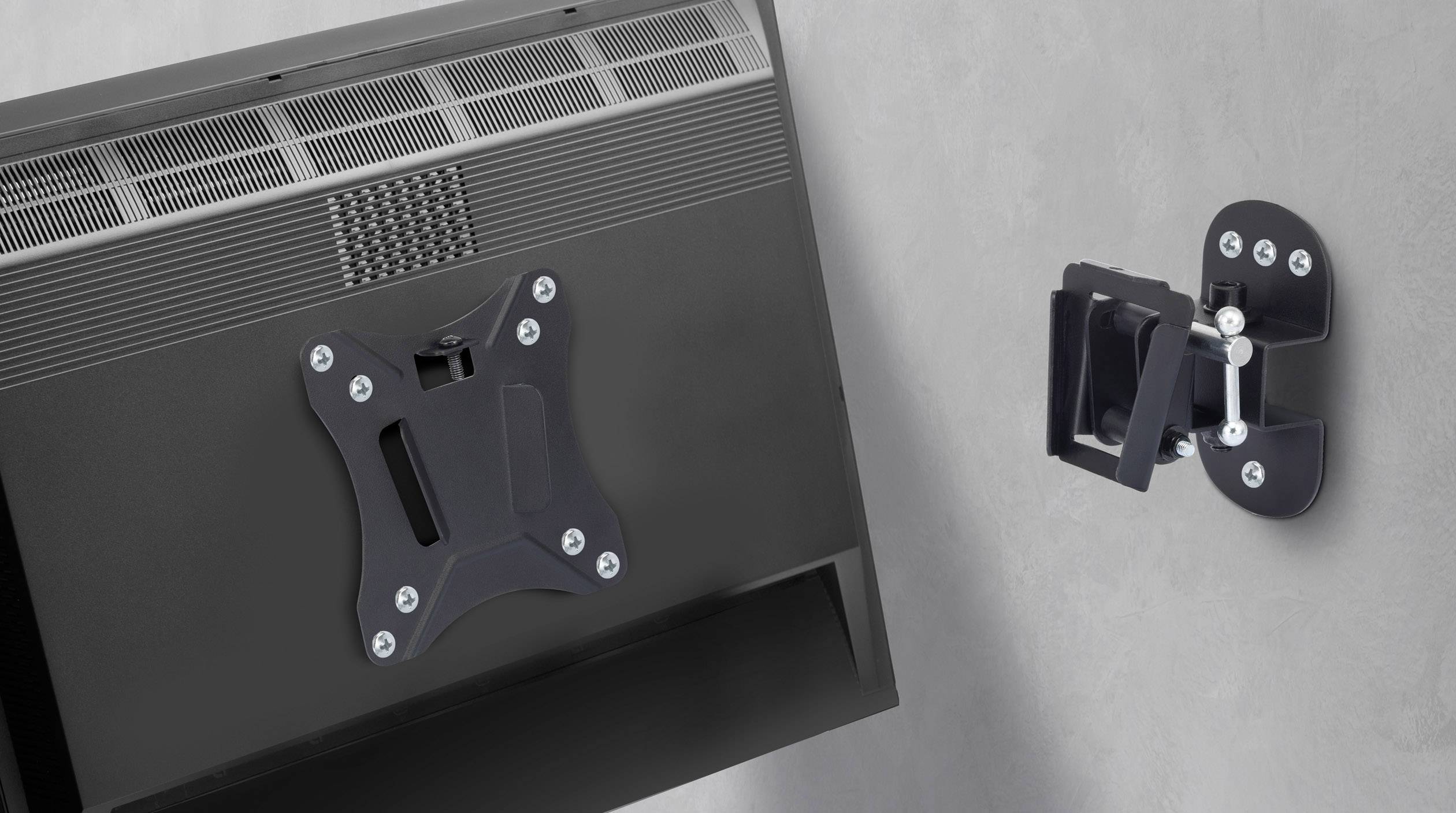 A black monitor wall mount is installed on a grey wall. It shows the front and back of the mounting bracket.