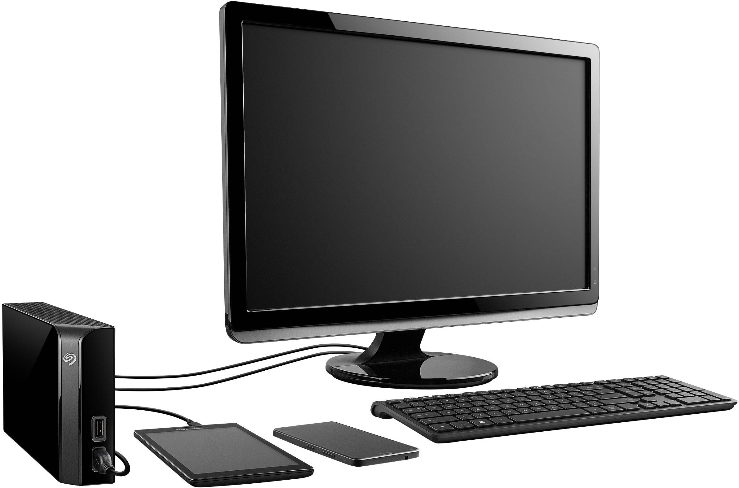 A desktop computer with monitor, keyboard and external hard drive. Two external devices are connected via cables.<br><br>(Note: This translation is already very close to British English. No significant changes were required.)