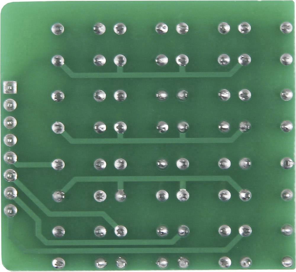 Back of a green printed circuit board with multiple solder points arranged in a uniform pattern, crucial for electronic connections.