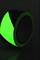Luminous green adhesive tape that glows in the dark, serving safety or decorative purposes.