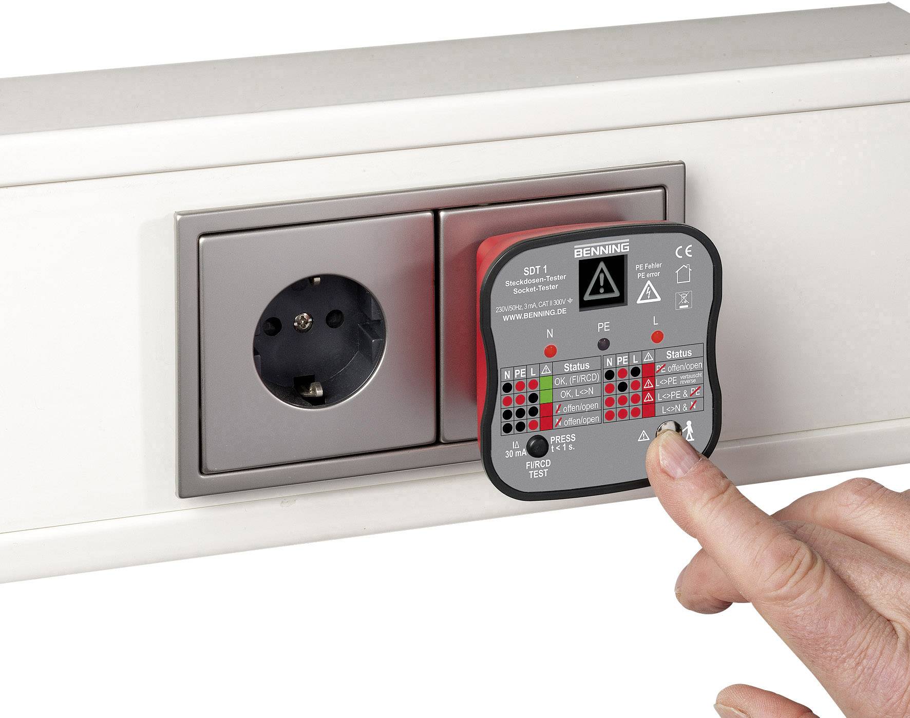 A hand is holding a testing device against a socket to check its functionality. The device displays various LED lights for status indicators.