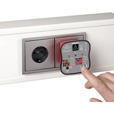 A hand is holding a testing device against a socket to check its functionality. The device displays various LED lights for status indicators.