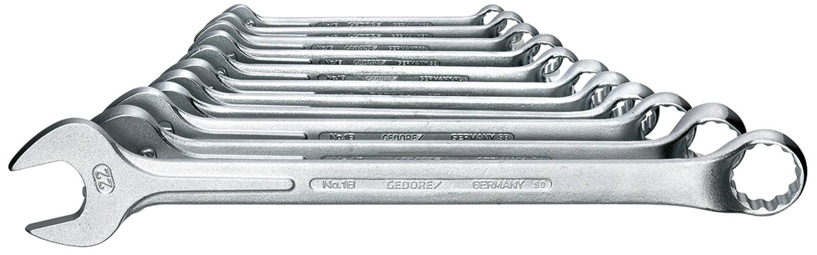 A stacked row of eight metallic spanners in varying sizes, arranged diagonally from front to back.