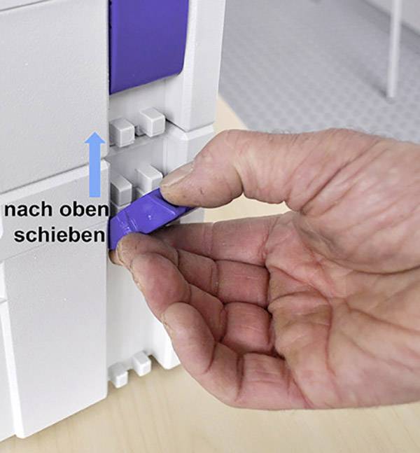 A hand is pushing a blue lever upwards, as indicated by a blue arrow and the text 'push upwards'.