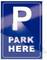 Blue sign with a large white letter 'P' and in smaller text 'PARK HERE', indicating a parking area.