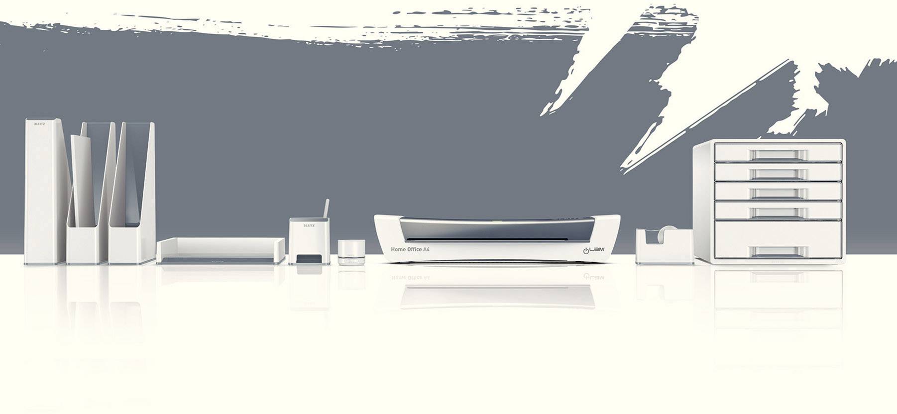 Modern white desk accessories against a grey wall. Includes document holder, letter tray, hole punch, stapler, and drawer box.