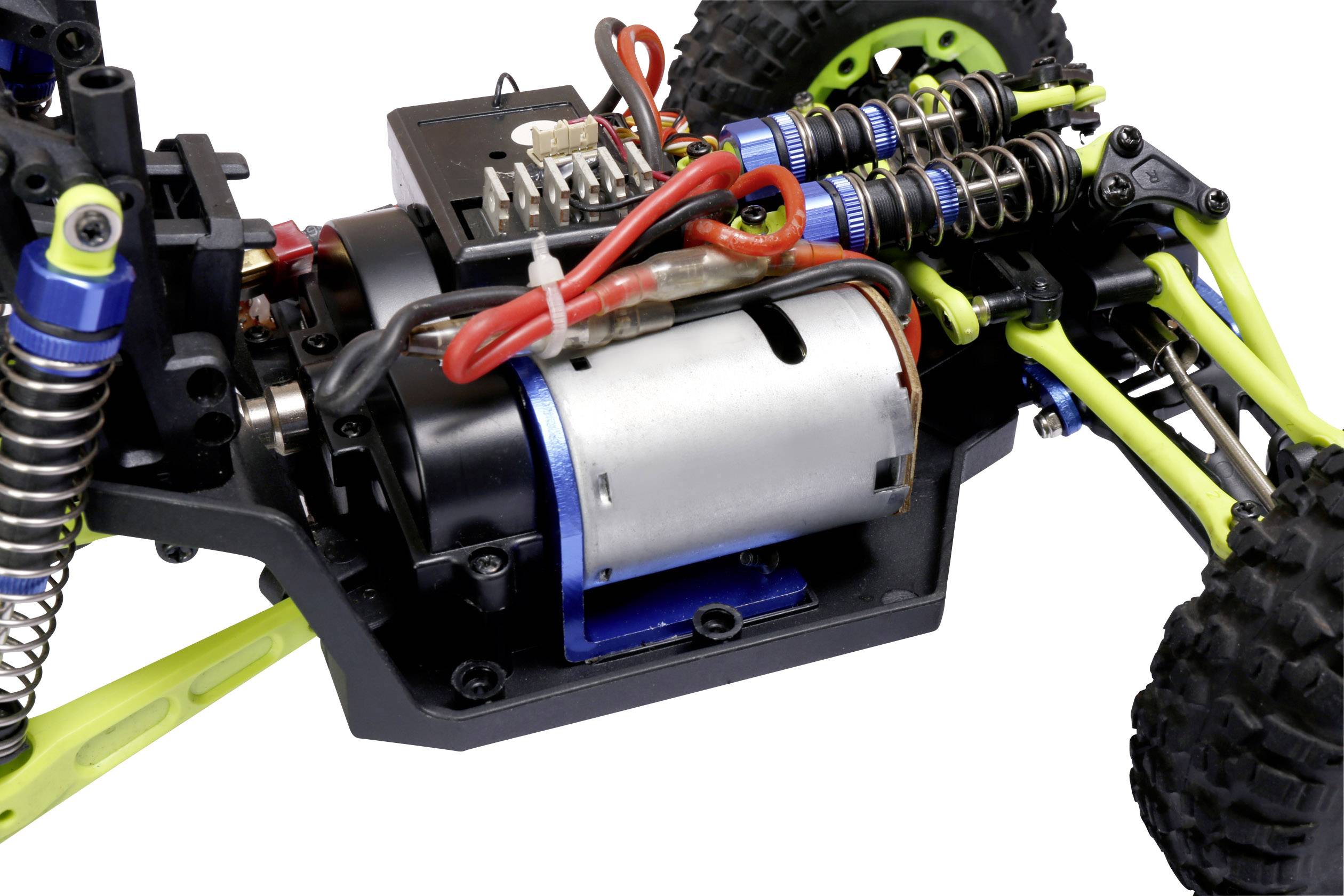 Close-up of a remote-controlled car with visible engine and suspension components.