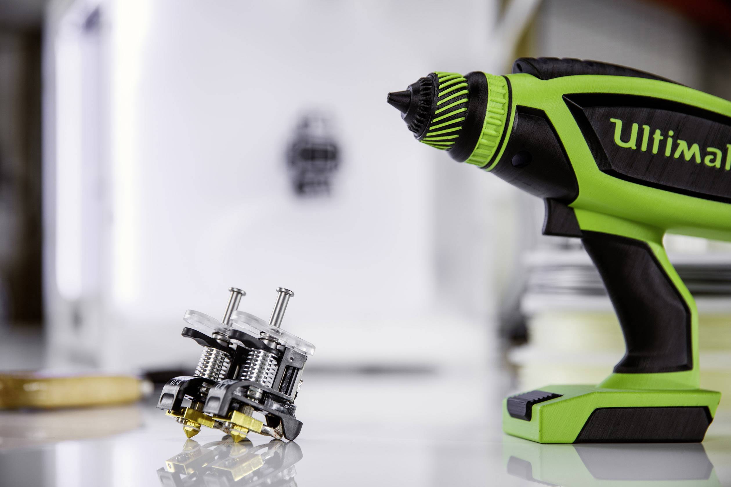 A close-up of an electric drill, with small metal components lying beside it, possibly for a construction project or repair task.