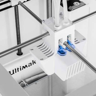 A 3D printer with a dual extruder system, which prints filaments in two colours or materials, is seen in operation.