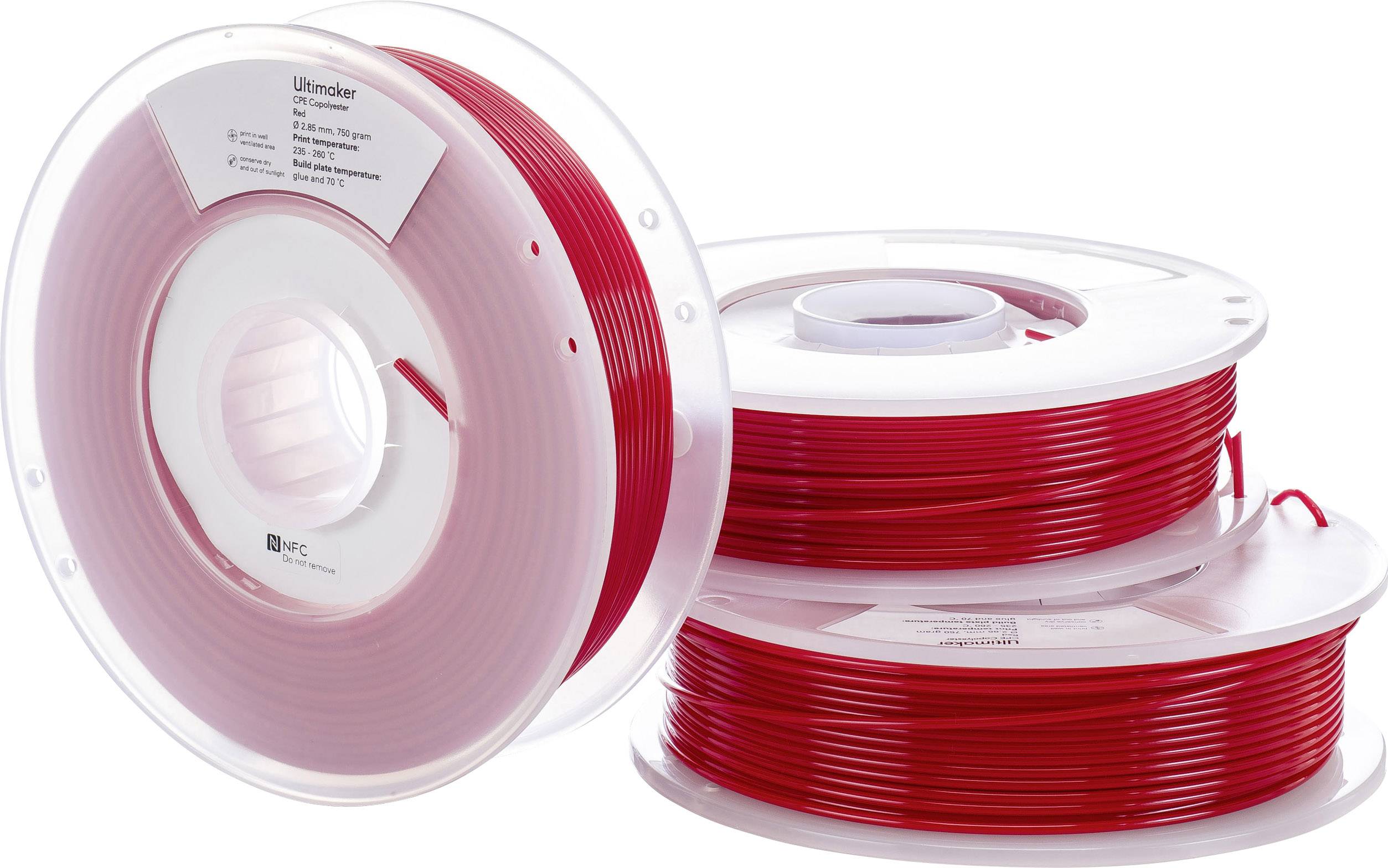 A reel of red 3D printer filament, standing upright. Beside it, two reels of the same filament lying horizontally.