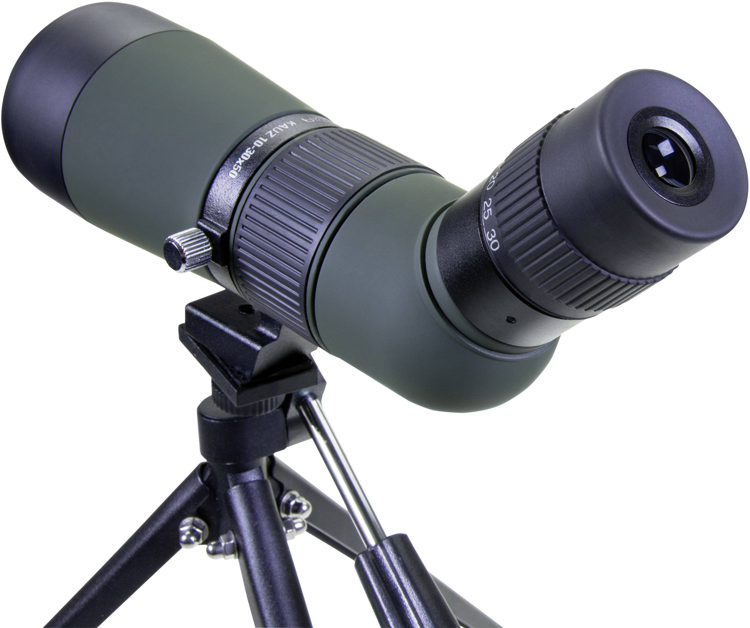 A green spotting scope with a tripod is ready for use. It is aimed at an object to observe distant details clearly.