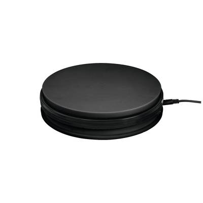 Black, round electrical device with cable on the right side, likely a heat storage unit or cooking appliance.