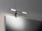 Wall light with a modern design above a mirror, brightly illuminating the room.