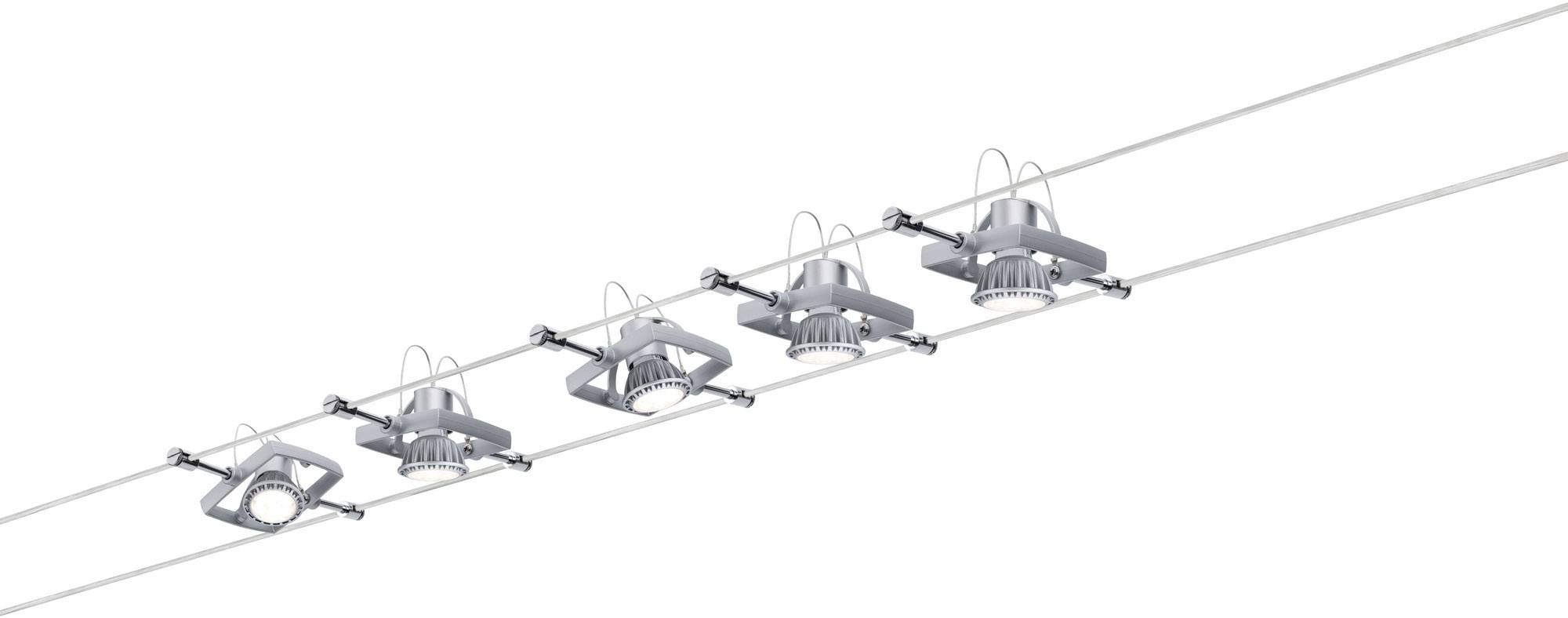 Five modern ceiling spotlights are mounted in a row on a cable system. The light fixtures are made of metal and have round LED lamps.