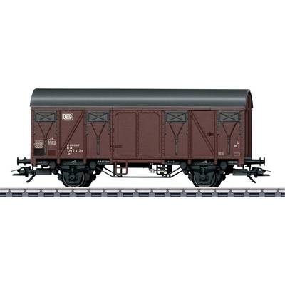 Goods wagon of Deutsche Bahn in brown colour on railway tracks.