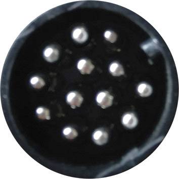 Close-up of a round, multi-pin connector with nine silver contacts arranged in three rows.