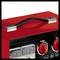 Red portable power generator with handle, two displays for voltage and current visible, red control knobs beside them.