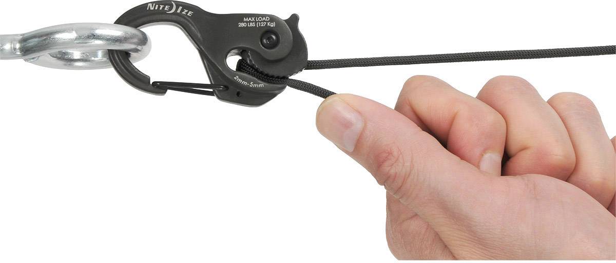 A hand pulls on a black, mechanical lock that is fastened with a hook to a metal ring.