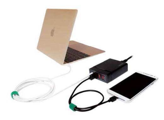 A laptop is connected to a charger via a cable, with a smartphone plugged into the charger.
