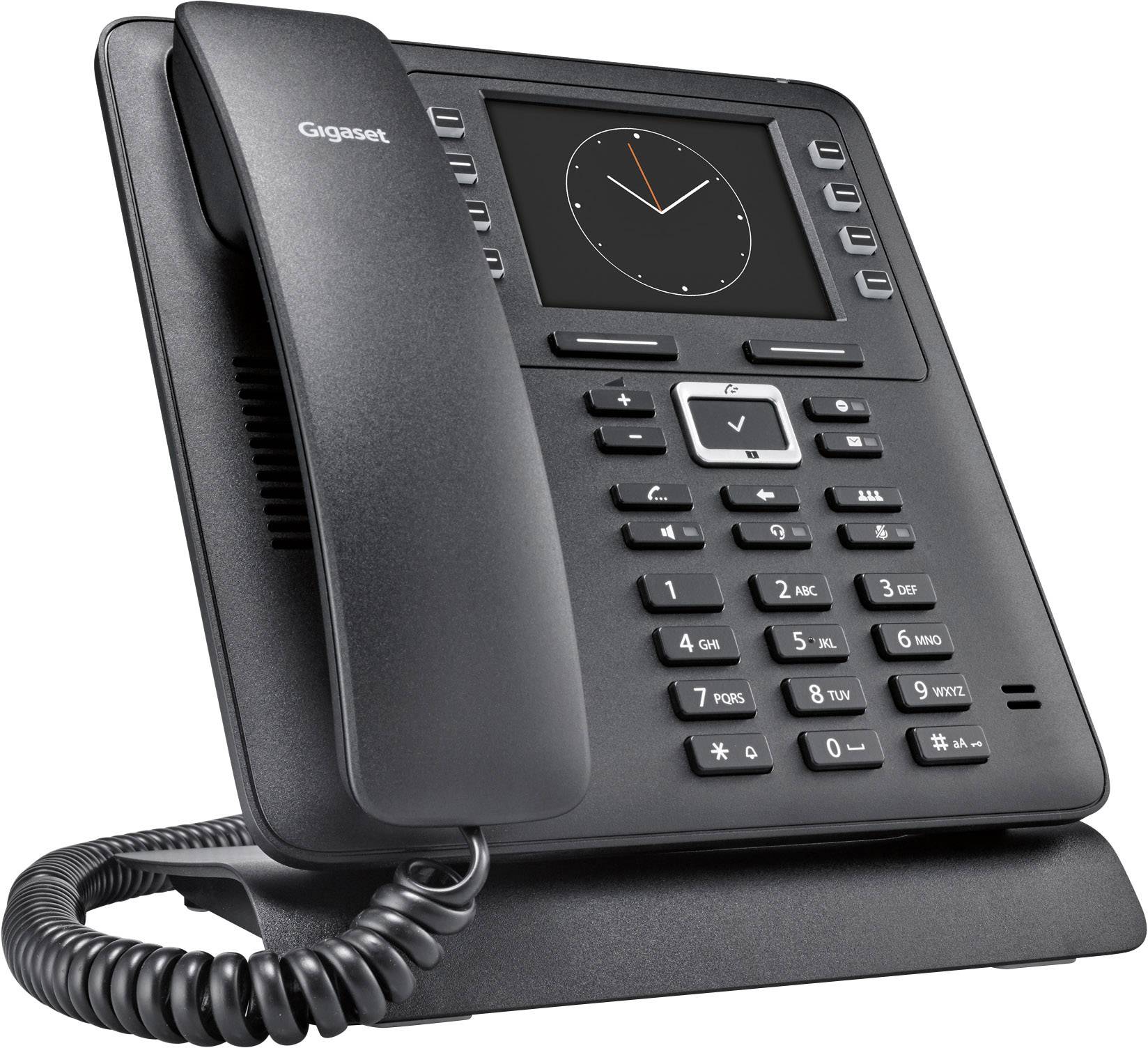 A black desk telephone with a large display and keypad. An analogue clock is shown on the display.