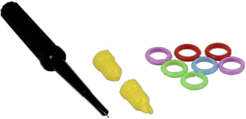 A black test probe holder, two yellow caps and eight coloured rings (purple, red, green, blue) are lying on a white surface.