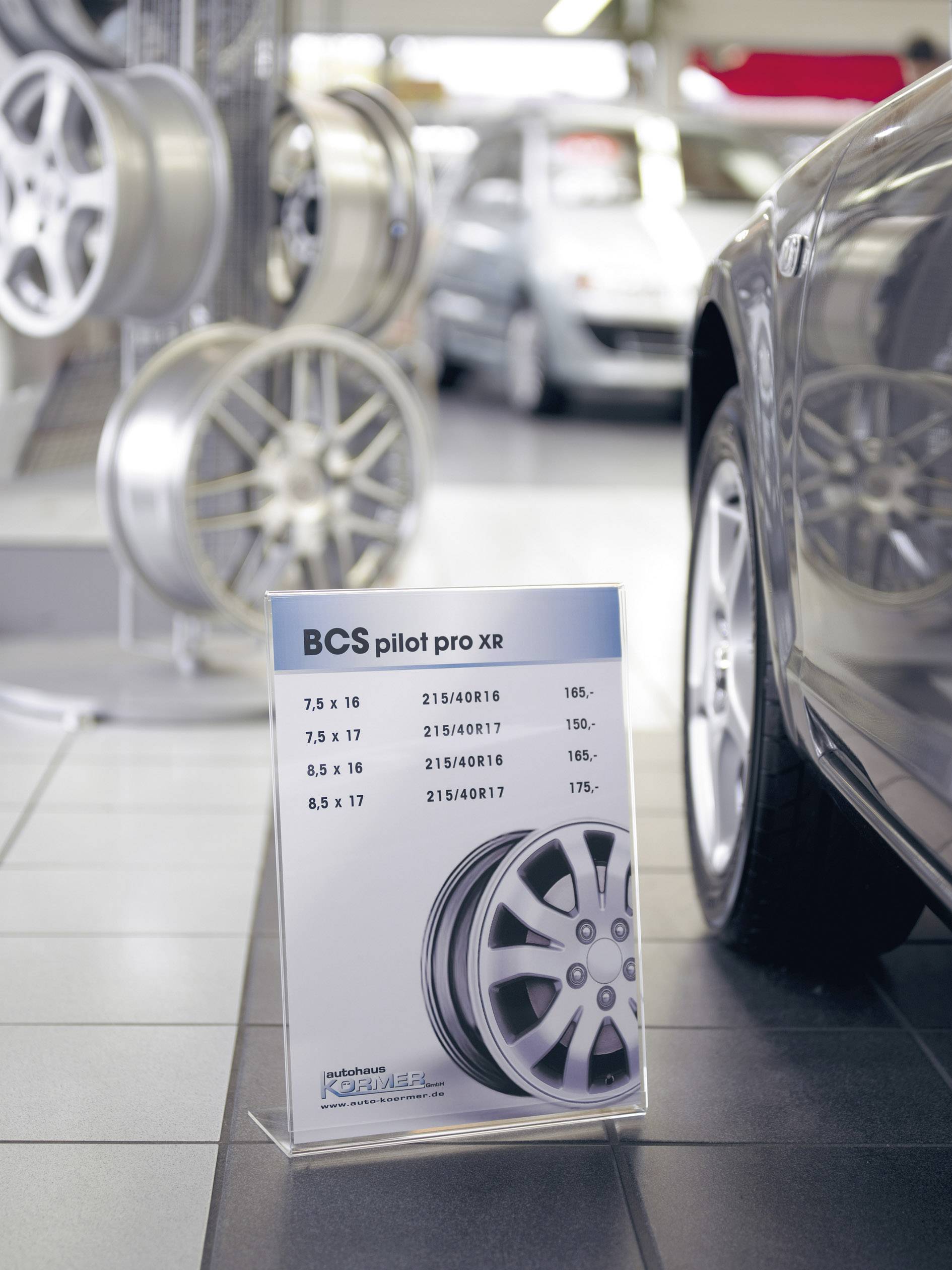 'Poster with rim data: BCS pilot pro XR. Sizes: 7.5 x 16, 8.0 x 17, 8.5 x 17. Pictured rims and car in the background.'
