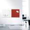 A desk with two pinboards on the wall; one white with the note 'Don't forget Dr. Müller 19.00' and one red.