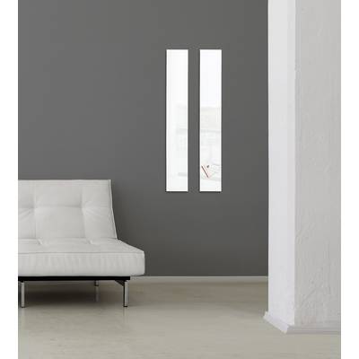 White modern sofa in front of a grey wall with two narrow windows; minimalist, tranquil room design.