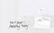 On a whiteboard, it reads 'Don't forget! Marketing Meeting'. Next to it, a business card and a diagram with bars and lines are pinned.