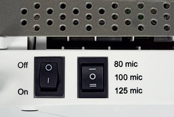 Switches and holes on a device. On the left, an on/off switch and on the right, a selector switch for micron stages: '80 mic', '100 mic', '125 mic'.