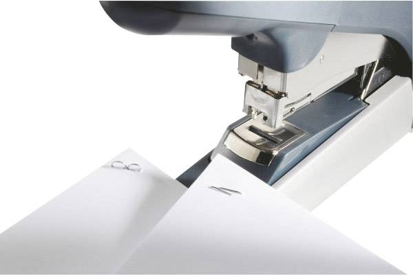 A stapler pushes staples into two overlapping sheets of paper.