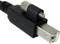 Close-up of a FireWire cable with a rectangular plug and metal locking mechanism.