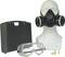 Mannequin with a respiratory mask, safety goggles, and suitcase. Green earplugs are lying beside it. Personal protective equipment set.
