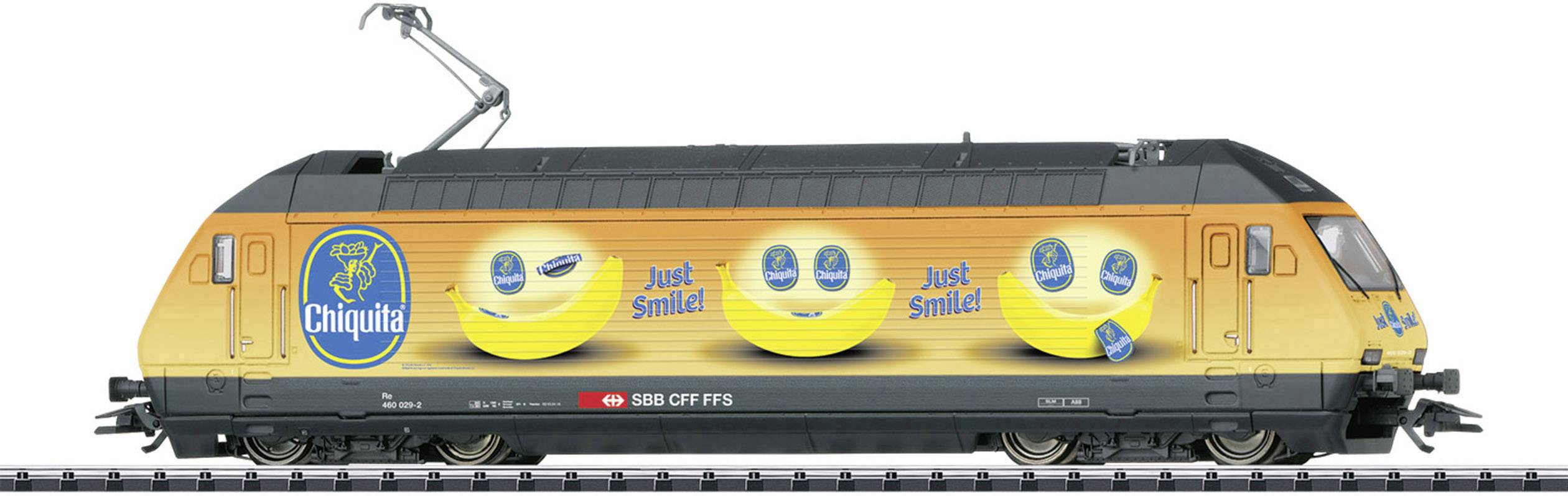 A locomotive of the Swiss Federal Railways with Chiquita advertising and large yellow smiley faces, accompanied by the slogan 'Just Smile!'.