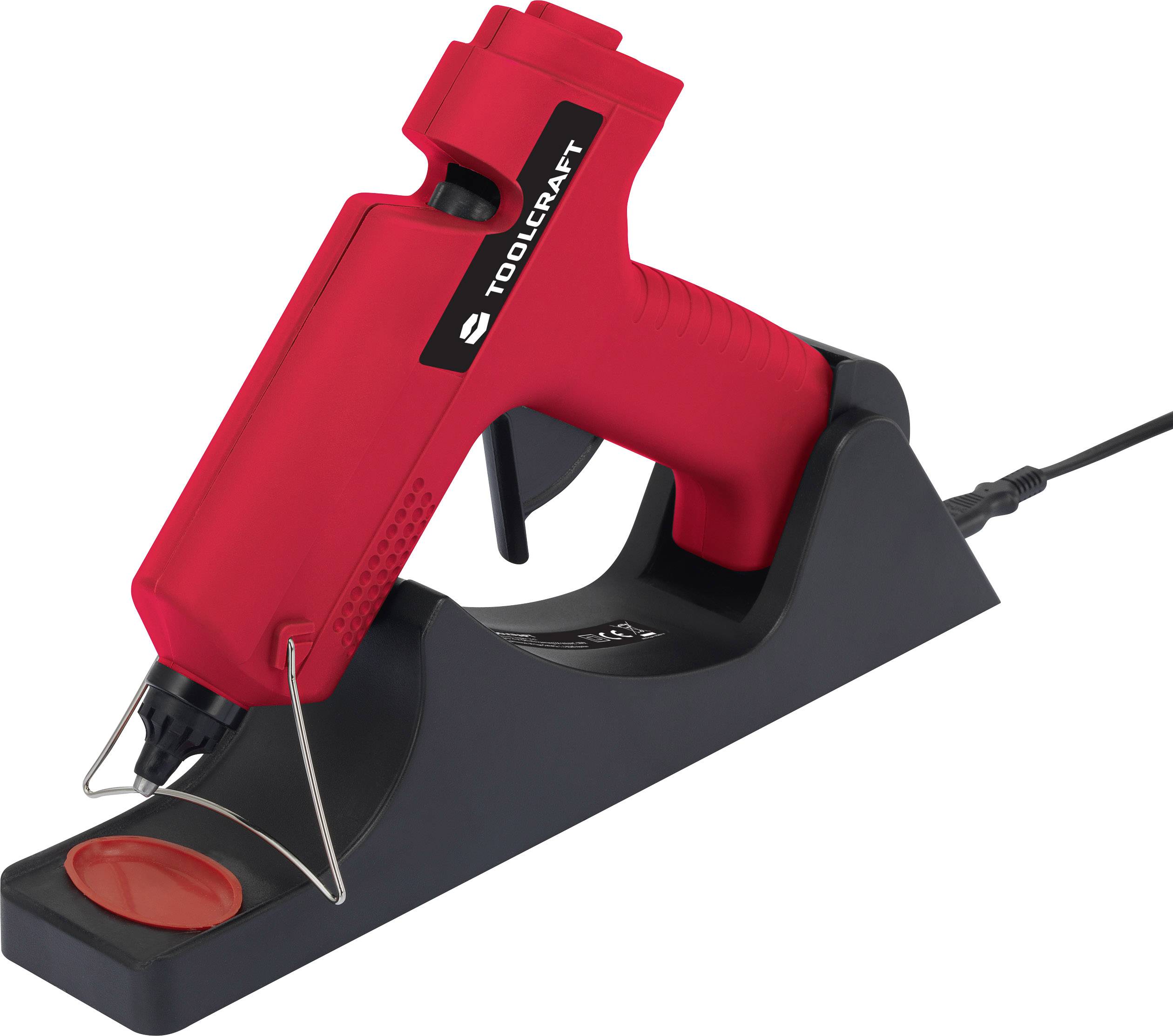 A red hot glue gun sits at an angle on a black base. A cable is connected to the base.