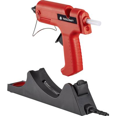 Electric hot glue gun in red on a black charging station.