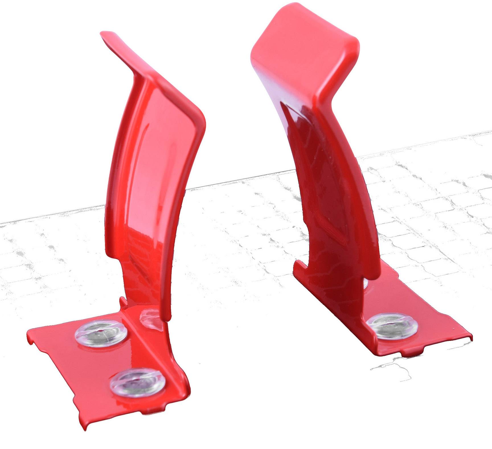 Two red, rectangular plastic clips with screws, positioned side by side on a grey background. They serve as a mounting or fastening device.