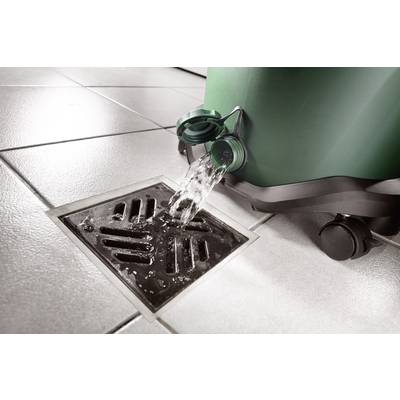 A green container is releasing water through a drain cover onto tiled flooring.