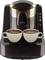 A black coffee machine with golden ornamentations preparing two cups of Turkish coffee with foam.