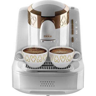 Coffee machine with two cups of freshly brewed, creamy coffee on top. Device in a modern design with golden embellishments.