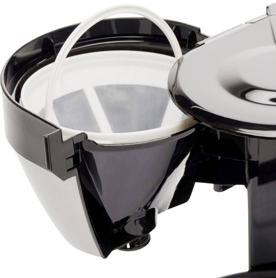 Close-up of an open filter coffee machine container with a removable plastic coffee filter insert and a black plastic housing.