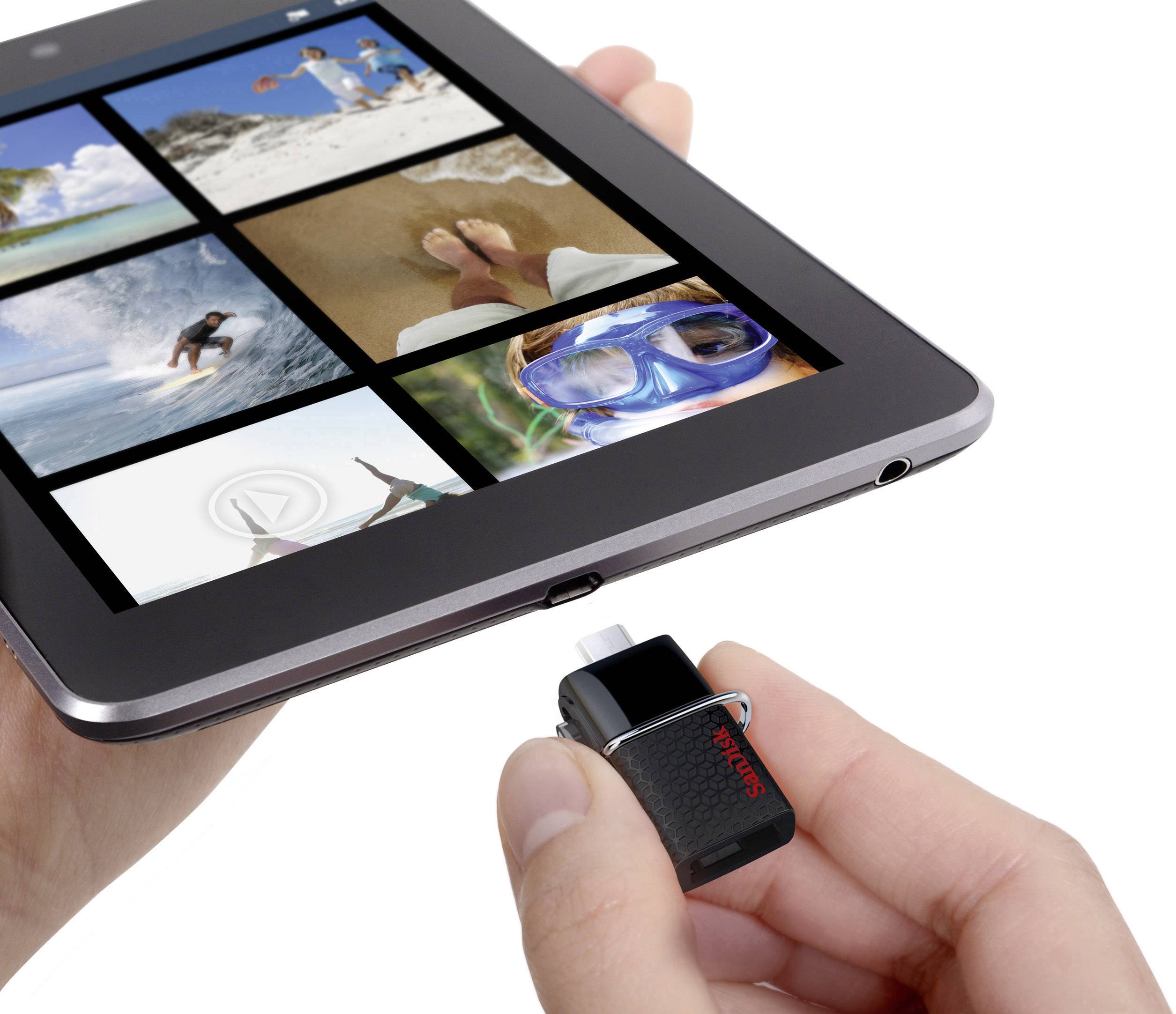 A person inserts a USB stick into a tablet that is displaying holiday photos on the screen.